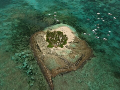 Guyam Island is a tiny, tear-drop shaped islet just off the coast of General Luna, Siargao in the Philippines. Known for its powdery white sand and dense canopy of coconut palms