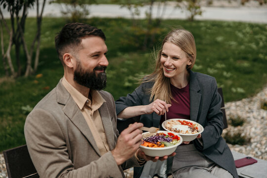 Business colleagues enjoying healthy lunch outdoors on break