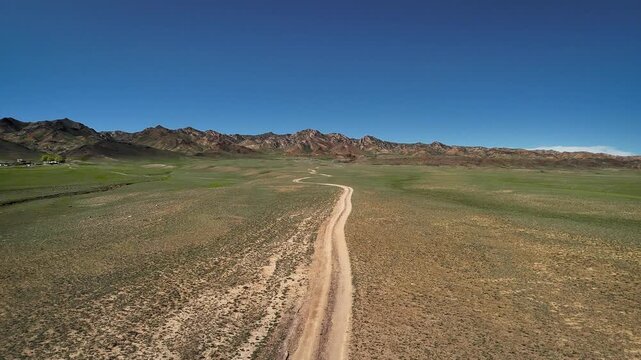 Drone shot of country road at spring steppe in Kazakhstan