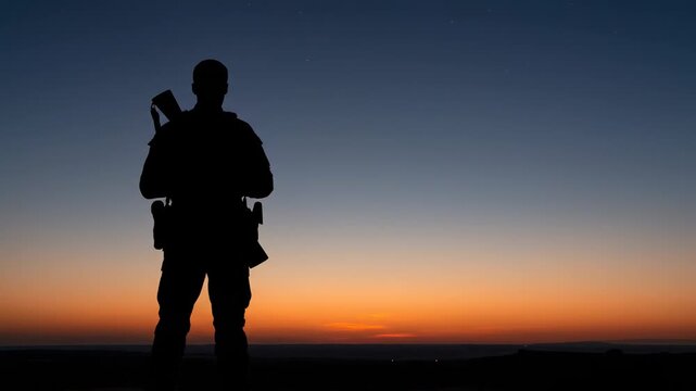Silhouetted armed individual against a gradient sunset sky