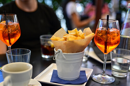 Aperol Spritz and ,cacio e pepe fried  potatoes tipical italian snack for aperitivo in a bar in ,Rome, Italy