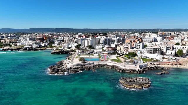 Monopoli Old Town with white houses. Aerial 4K drone video footage with panorama view of scenic Adriatic sea coastal cityscape in Puglia, southern Italy