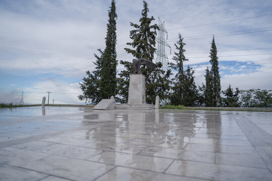 Monument to Leonidas at Thermopylae Greece with Tall Cypress Trees and Power Lines