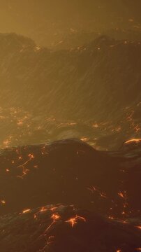 Lava flows down rocky surfaces under a warm sky. The light reflects off the lava, giving a bright orange glow. This scene shows the activity of a volcanic area in motion.