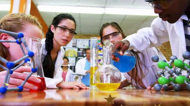 Students leaning in right student pouring blue into yellow flask for chemistry lab stars over flask