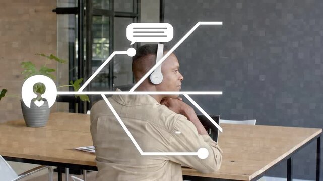 Man touching laptop, causing speech bubbles and lines to form AI icon at shoulder analyzing tech
