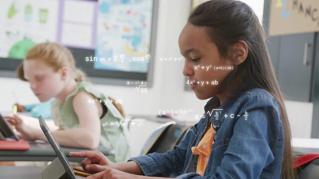 Female student typing on tablet in classroom, tapping sparking math overlays showing progress