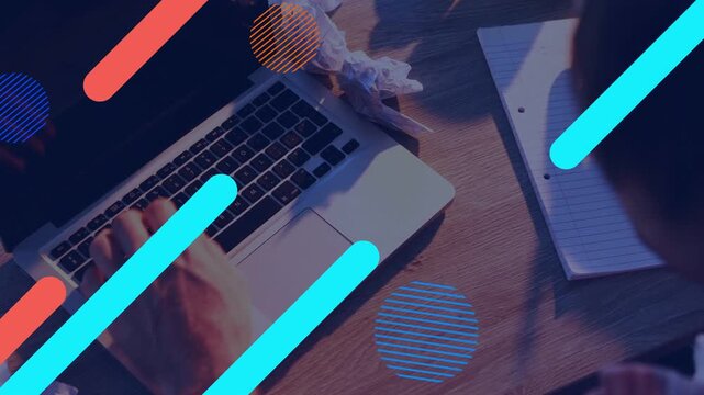 Man switching from typing to noting for study, typing causing graphics hiding laptop and notebook
