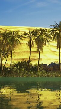 Tall palm trees stand near a calm lake. Behind them, golden sand dunes rise under a clear blue sky. The scene shows natural beauty and sunlight reflecting on the water surface.