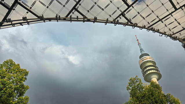 Munich, Germany. September 27, 2025. View of the Olympic Tower Olympiaturm, green tree and futuristic designs of stadium in the Olympia stadium Olympiapark.