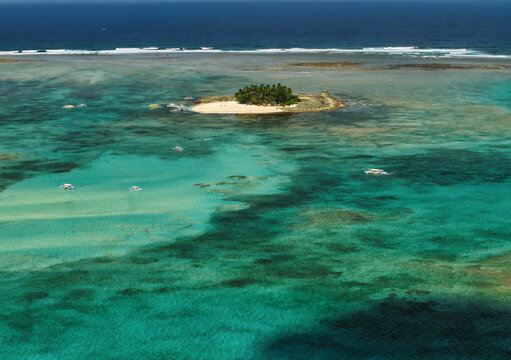 Guyam Island is a tiny, tear-drop-shaped tropical paradise located just 2 kilometers (1.2 miles) off the coast of General Luna, Siargao, in the Philippines. Famous for its powdery white sand beaches 