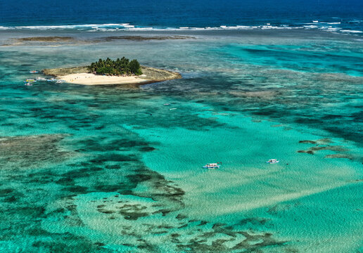 Guyam Island is a tiny, tear-drop-shaped tropical paradise located just 2 kilometers (1.2 miles) off the coast of General Luna, Siargao, in the Philippines. Famous for its powdery white sand beaches 