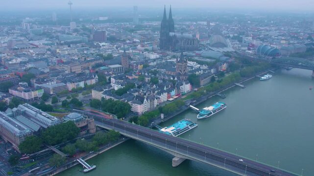  Aerial panorama view above the old town of the city cologne on a rainy, cloudy and foggy morning in summer.