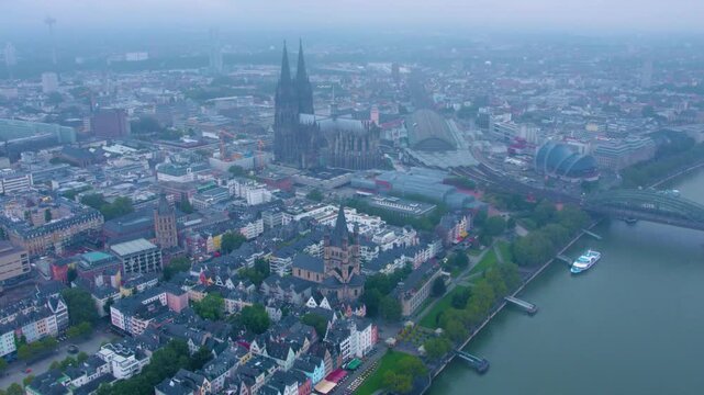  Aerial panorama view above the old town of the city cologne on a rainy, cloudy and foggy morning in summer.