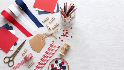 Obraz premium Patriotic Craft Supplies Flatlay with Ribbon Scissors Buttons and Stationery for Independence Day DIY Holiday Decoration Project Ideas