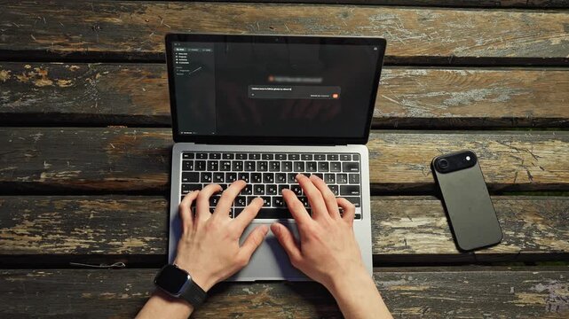 Overhead Hands Typing MacBook iPhone on Wooden Bench