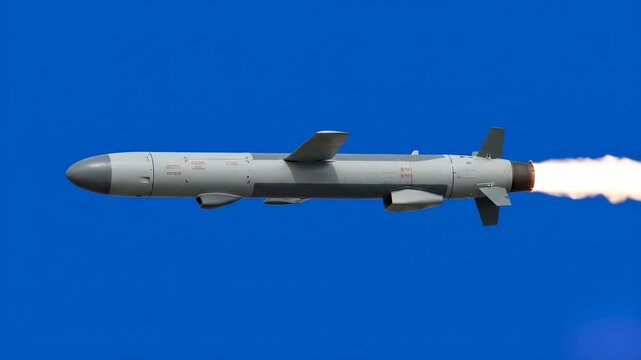A detailed three-dimensional metallic military rocket or cruise missile flies horizontally across a bright blue chroma key background. This pre-keyed defense weapon asset is designed for easy composit