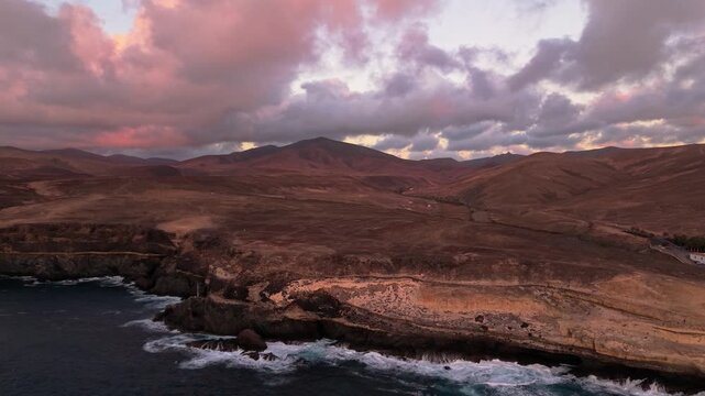 Aerial view of Ajuy village in sunset, which is a region and hamlet in the municipality of Pajara on the island of Fuerteventura, Canary Islands, Spain. Drone POV exploration of Fuerteventura Island. 