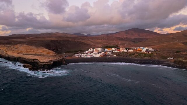 Aerial view of Ajuy village in sunset, which is a region and hamlet in the municipality of Pajara on the island of Fuerteventura, Canary Islands, Spain. Drone POV exploration of Fuerteventura Island. 