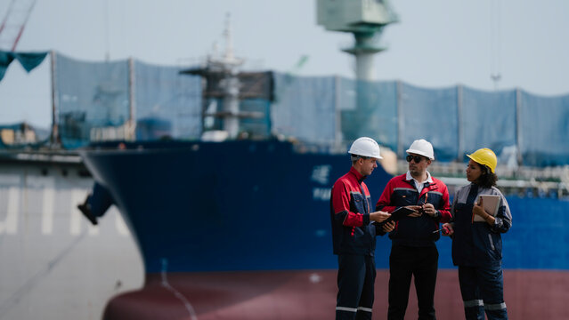 Happy team professional engineer, worker, technician use clipboard discuss work, walk in steel metal manufacture factory plant industry. engineer at commercial shipping port terminal