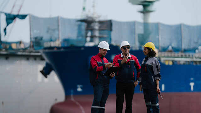 Happy team professional engineer, worker, technician use clipboard discuss work, walk in steel metal manufacture factory plant industry. engineer at commercial shipping port terminal