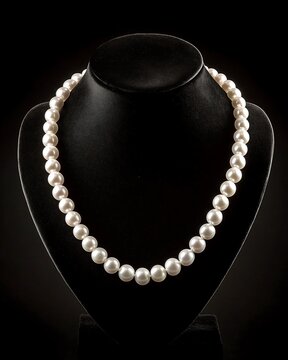 Single strand pearl necklace on black velvet bust stand