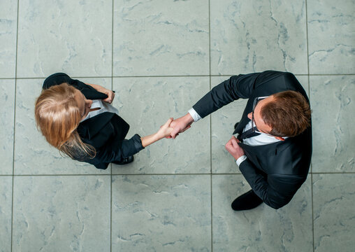 Business handshake top view.