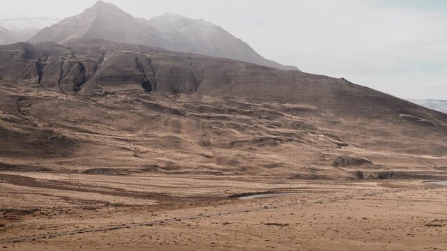 Bus Driving Through Patagonian Landscape on Scenic Road