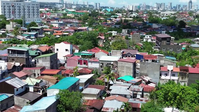 Aerial footage of urban residential environment and tightly packed buildings in Cebu City Philippines.