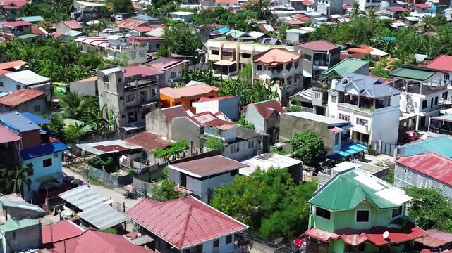 Aerial footage of urban residential environment and tightly packed buildings in Cebu City Philippines.