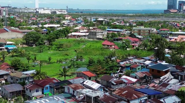 Aerial footage of urban residential environment and tightly packed buildings in Cebu City Philippines.