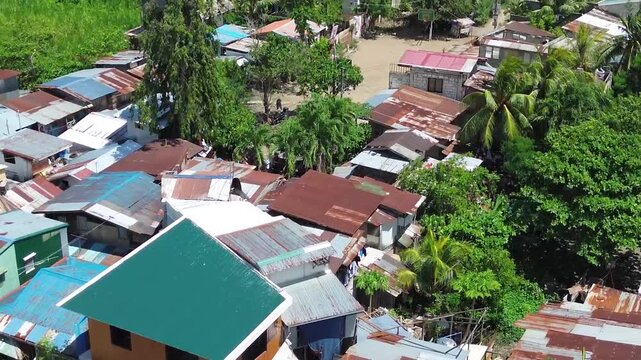 Aerial footage of urban residential environment and tightly packed buildings in Cebu City Philippines.
