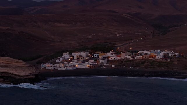 Aerial view of Ajuy village in sunset, which is a region and hamlet in the municipality of Pajara on the island of Fuerteventura, Canary Islands, Spain. Drone POV exploration of Fuerteventura Island. 