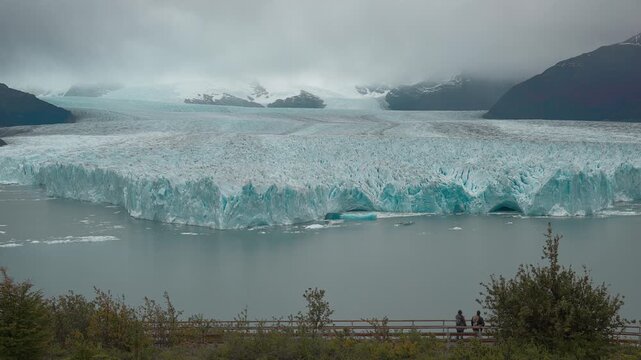 People Walking on Boardwalk Below Perito Moreno Glacier in Patagonia