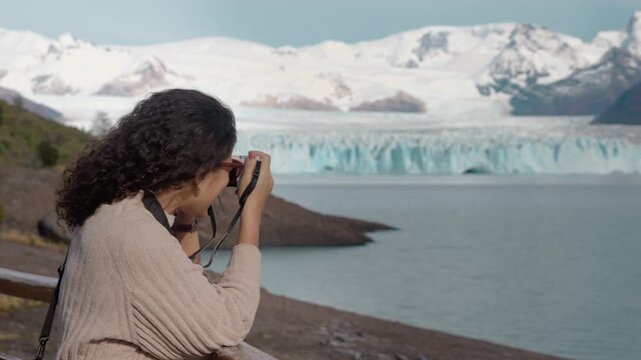 Female Traveler Photographing Perito Moreno Glacier in Patagonia