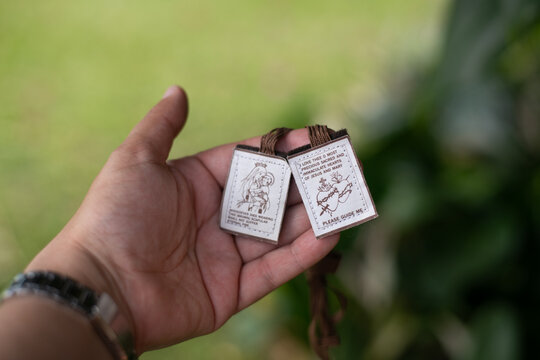 Traditional Catholic brown scapular on wooden surface