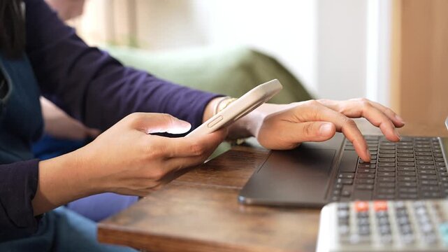 Young mother using smartphone and laptop while spending time with her little son at home, remote work, digital parenting, multitasking lifestyle and family work life balance concept.