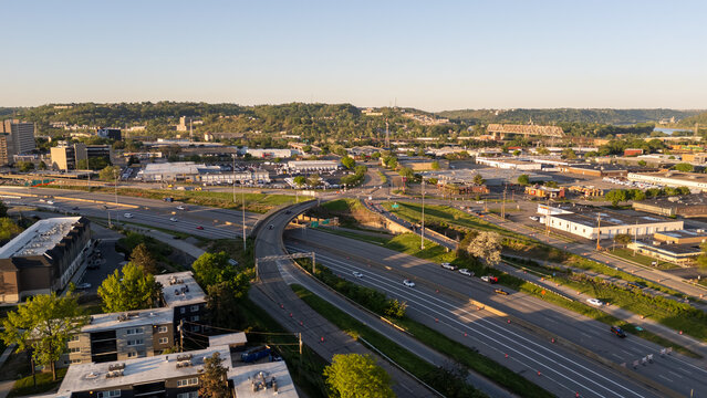 Aerial view of long highway freeway passing among green fields