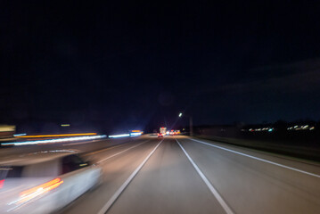 Point of view driving on highway among blurred car lights night © Midea 