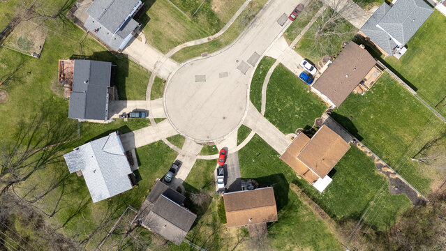 Aerial view of green cul de sac residential street neighborhood