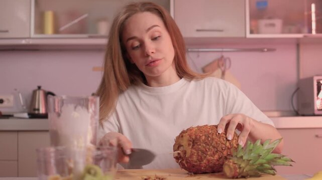 Closeup of pineapple slicing process. Hands expertly cutting pineapple into rings. Closeup footage showcasing detailed process of preparing fresh pineapple for cooking