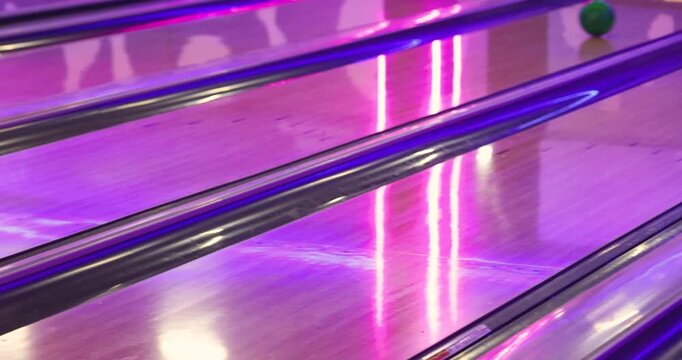 Bowling club play, group team of friends and colleagues playing, throwing a ball on the bowling alley lane, ball and pins, corporate party event in a mall amusement game center, tournament competition