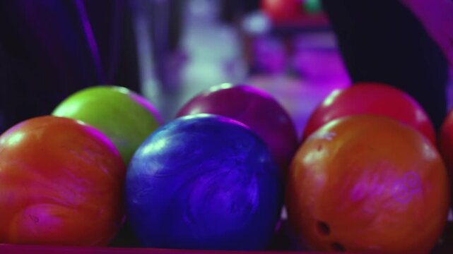 Bowling club play, group team of friends and colleagues playing, throwing a ball on the bowling alley lane, ball and pins, corporate party event in a mall amusement game center, tournament competition