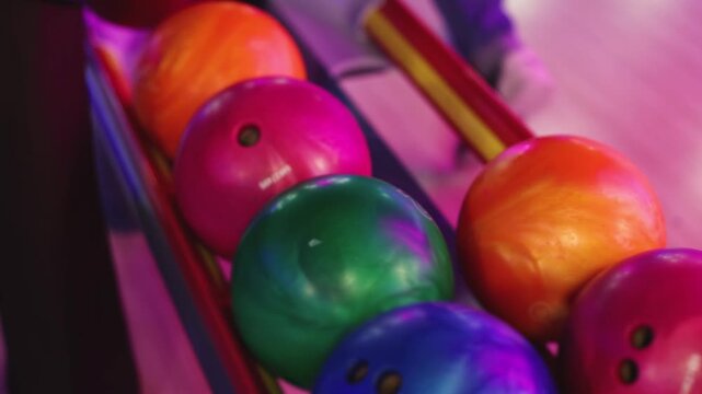 Bowling club play, group team of friends and colleagues playing, throwing a ball on the bowling alley lane, ball and pins, corporate party event in a mall amusement game center, tournament competition