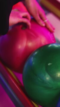 Bowling club play, group team of friends and colleagues playing, throwing a ball on the bowling alley lane, ball and pins, corporate party event in a mall amusement game center, tournament competition