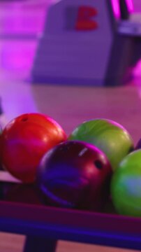 Bowling club play, group team of friends and colleagues playing, throwing a ball on the bowling alley lane, ball and pins, corporate party event in a mall amusement game center, tournament competition