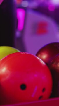 Bowling club play, group team of friends and colleagues playing, throwing a ball on the bowling alley lane, ball and pins, corporate party event in a mall amusement game center, tournament competition