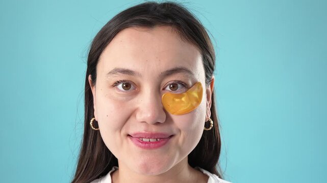 Close Up of Woman Applying Golden Under Eye Patches