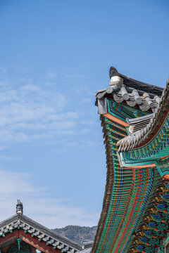 Traditional dancheong patterns on the wooden eaves of an ancient korean palace building