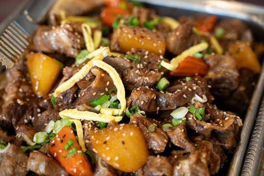 Close up of Korean braised beef short ribs with vegetables.